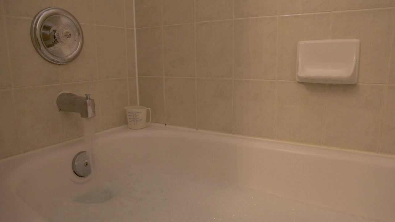 A bubble bath is being filled.