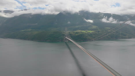 epic aerial next to hardanger suspension bridge over fiord, scenic landscape