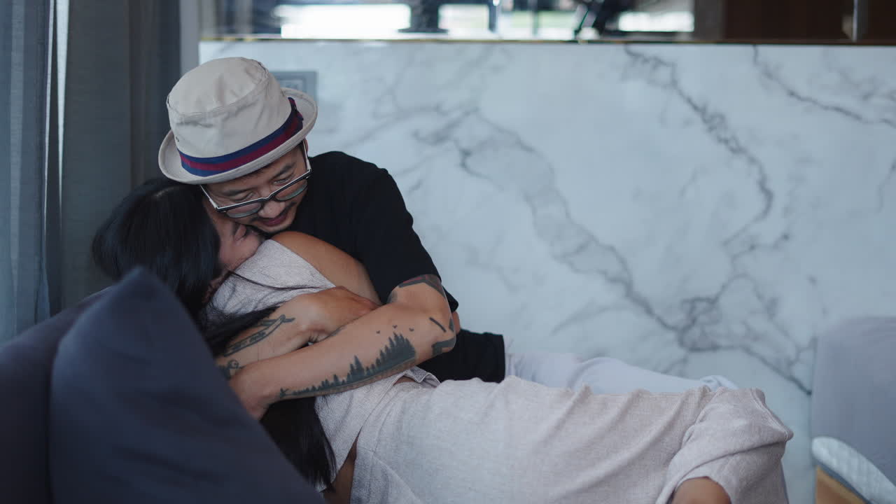 Couple hugging on couch