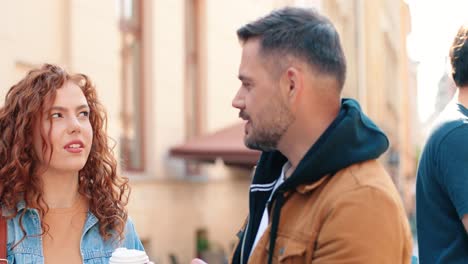 close-up view of redheaded woman holding coffee to go