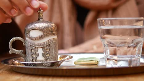 woman enjoying turkish coffee at a cafe