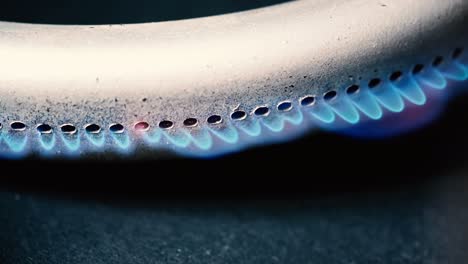 burning gas burner in the oven close-up on a black background. 4k macro raw video.