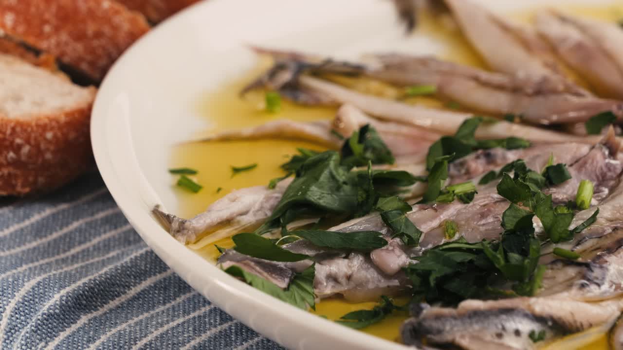 Fresh Sea sardines and Anchovy Fish and Mullus On Display On Ice On Market Store Shop. Seafood Fish Background, close up stand of small salty white fish.