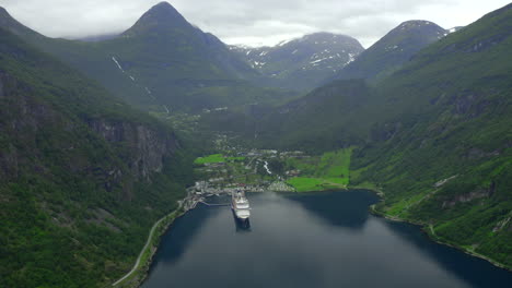 majestic areal crane shoot of geiranger city and geiranger fjord