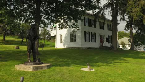 statue at the front of original historic house of josiah stowell friend of joseph smith hired him for money or treasure digging in the early 1820s where he stayed when he got married