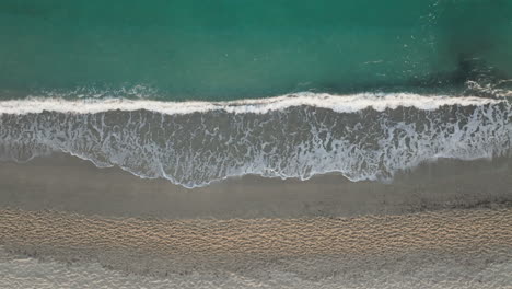 aerial view of a beautiful beach with turquoise water and white waves