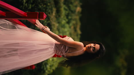 Beautiful-woman-wearing-pink-corset-fairy-lace-dress-turning-around-smiling-in-forest