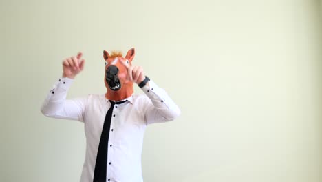 funny man in latex horse mask dancing isolated on background funny man in latex horse mask dancing isolated on background
