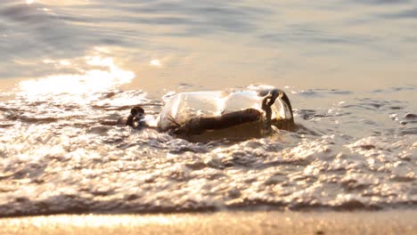 Message-in-the-bottle-against-the-Sun-setting-down