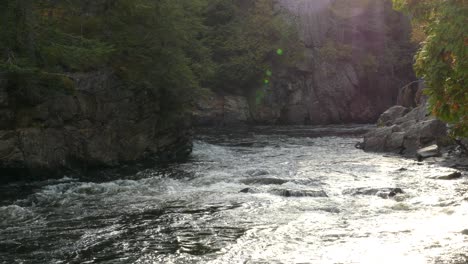 Beautiful-river-flowing-through-giant-rock-walls-creating-imposing-natural-walls