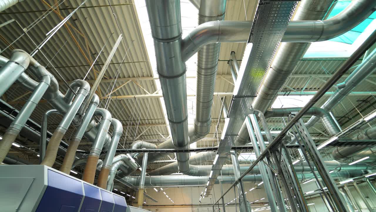 Industrial factory ceiling with ventilation system and lights. Ventilation ducts.