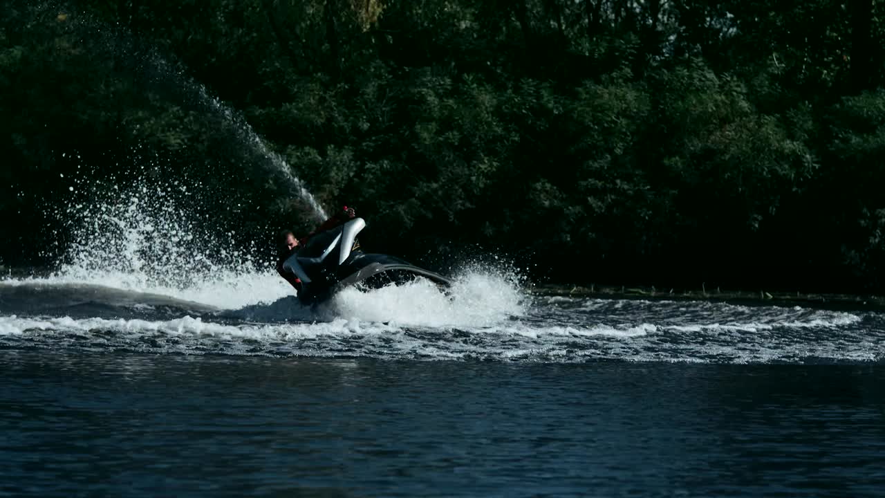 Sportsman swirling on speedy jet ski on river. Extreme water sport concept