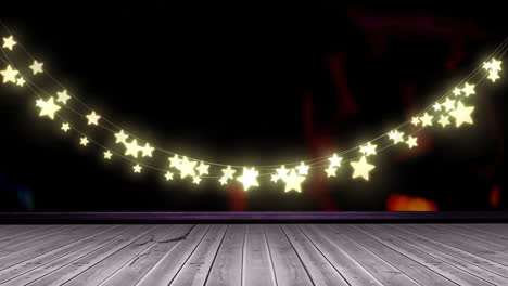 glowing yellow star shaped fairy light decoration hanging over wooden plank
