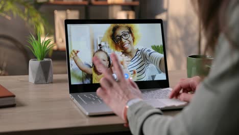 Woman-Video-Calling-On-Laptop-And-Talking-With-Happy-Female-Friend-And-Her-Daughter-Indoor