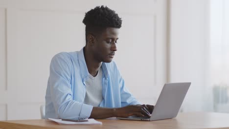 Young Man Working on Laptop, Eye Strain