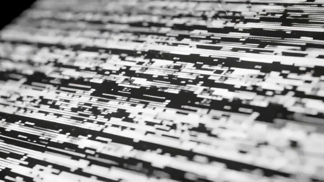 Shifting glitchy pixel pattern moving on monitor surface, camera focus shift causing blocks to grow