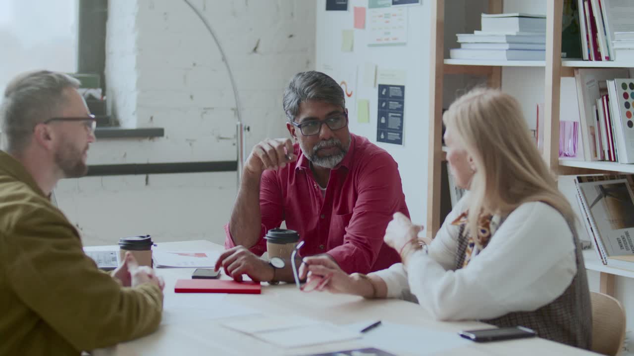 Business Team Discussing Ideas on Informal Meeting in Modern Office