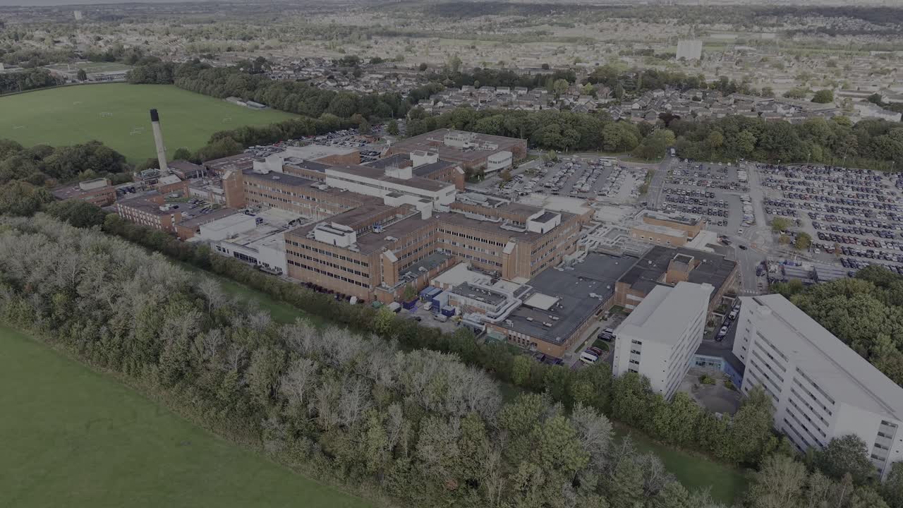 Arrowe Park NHS WUTH Trust Hospital on a sunny autumnal afternoon, drone approach then rotate and move out - Wirral, UK