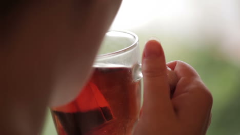 cup of tea in hands and cold rain