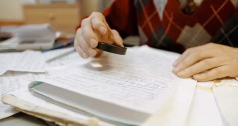 senior businessman writing on paper at table in office 15