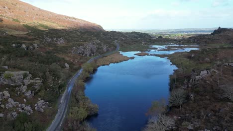 Wide-drone-shot-of-Gap-of-Dunloe,-Bearna-or-Choimín,-a-mountain-pass-in-County-Kerry,-Ireland