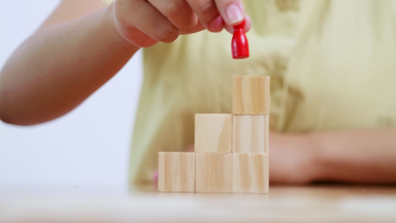 A child enhances fine motor skills by stacking blocks a playful home setting