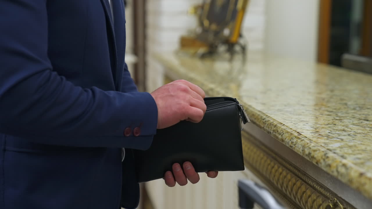 Traveler arriving at his hotel. Successful mature businessman sitting in hotel lobby