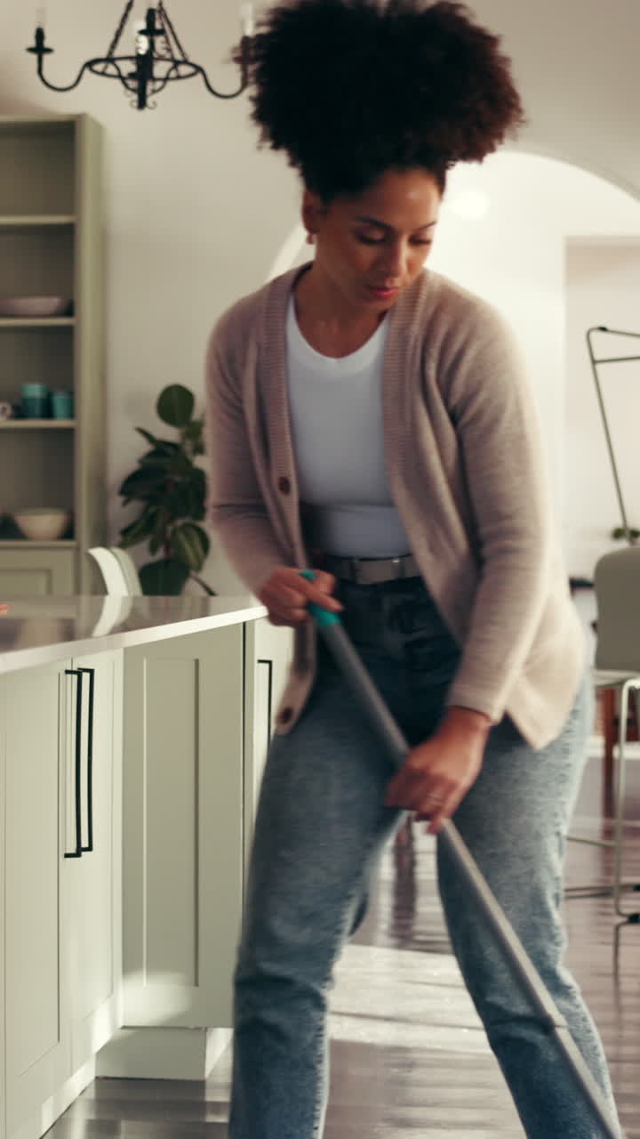Woman Mopping Hardwood Floor in Modern Kitchen