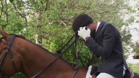 african american man riding his dressage horse