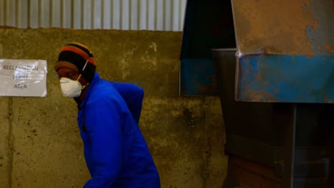 worker putting soil in machine at foundry workshop 4k