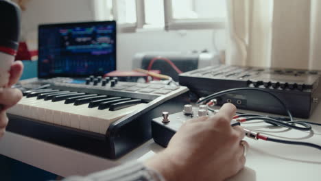 young singer recording a song at home music studio