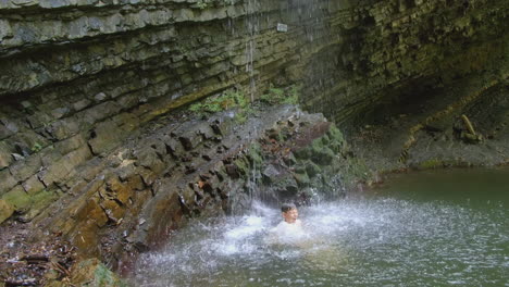 child playing in a waterfall