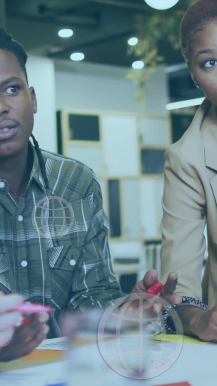 Animation of globes with data processing over diverse business people working in office