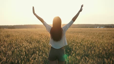 woman enjoying sunset in a wheat field