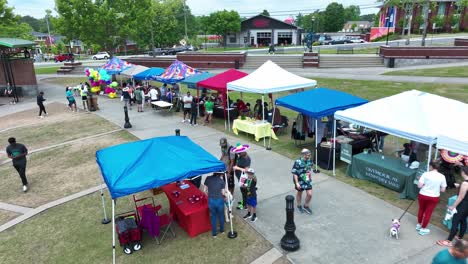 booths selling variety of goods suwanee town center during tacos and tequila event in suwanee, georgia. drone shot