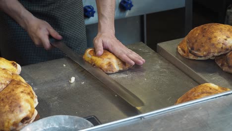 preparing and slicing pita bread in a commercial kitchen