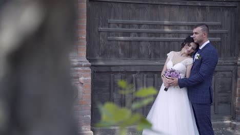 pretty bride in long dress leans on husband slow motion