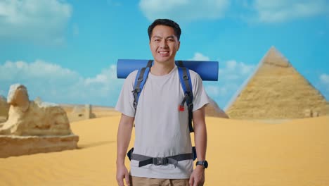 man with backpack in front of the pyramids