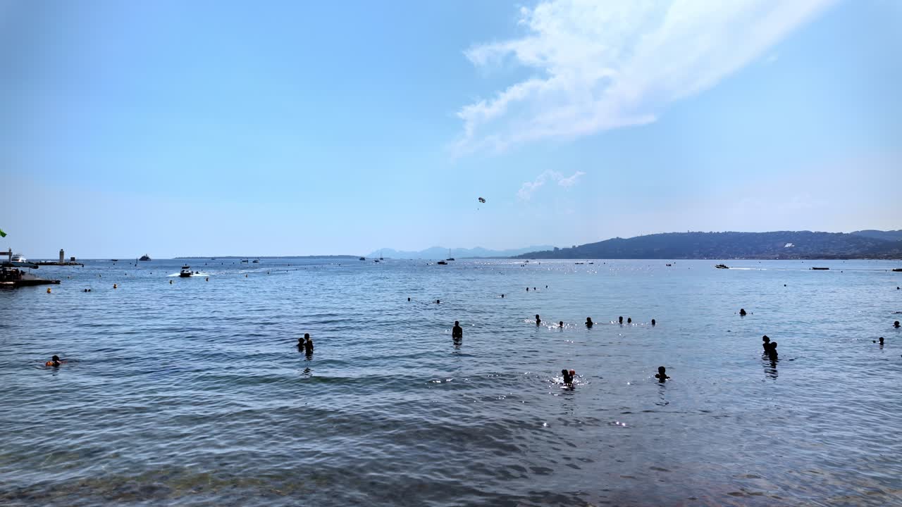 People swimming in the sea and relaxing on the beach in Juan-les-Pins, France