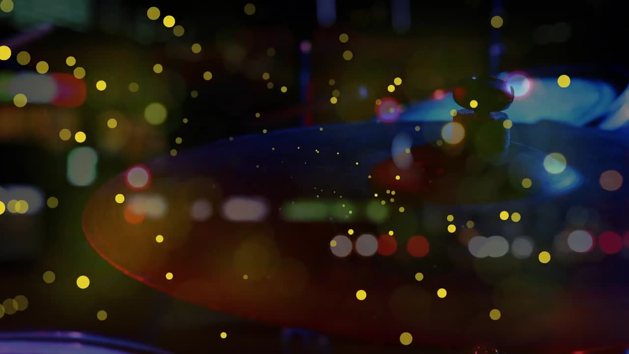 Animation of light spots over drums and cityscape