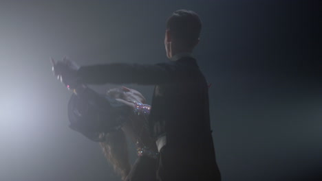 Professional-dance-couple-rehearsing-in-dark-space.-Ballroom-dancers-dancing.