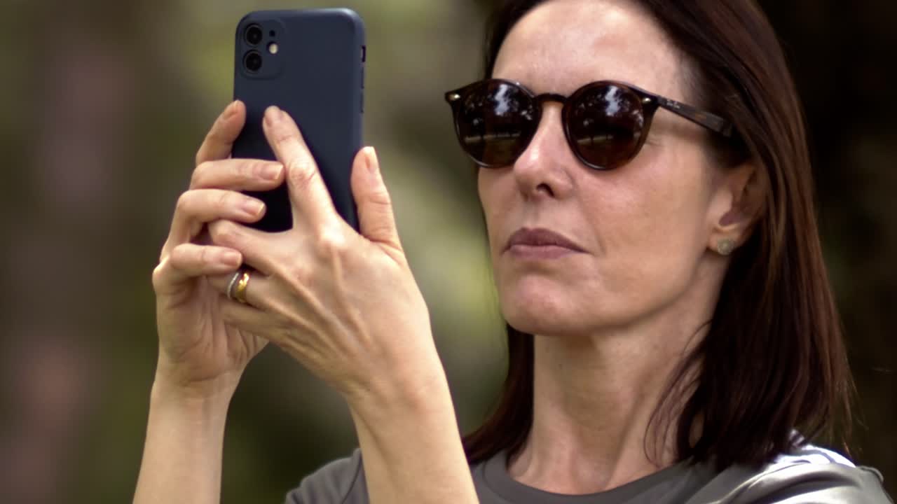 Optical reflections, phone device, Latin beautiful brunette, slow-mo