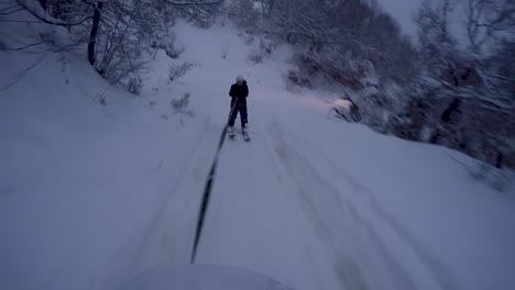 skier being pulled by an off-road car