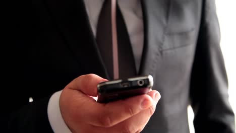 Businessman-Hands-Using-Mobile-Phone-3