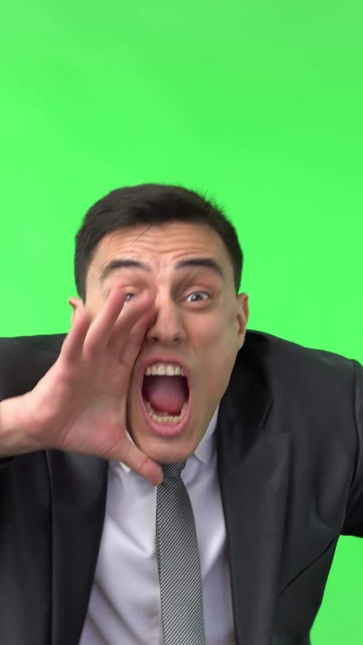 Man shouting and yelling on a green screen
