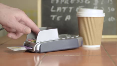 hand paying by card in cafe medium shot