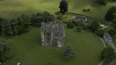 an elizabethan castle ruins in shadow on a warm summers afternoon