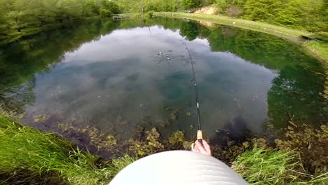 Catching-A-Freshwater-Fish-Off-From-A-Dock-Of-A-Remote-Lake