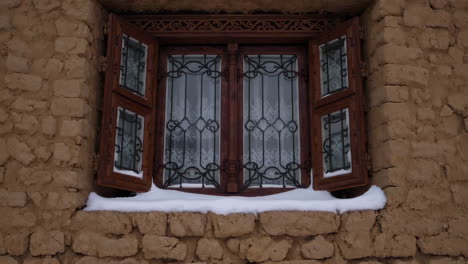 snowy mountain village with adobe houses