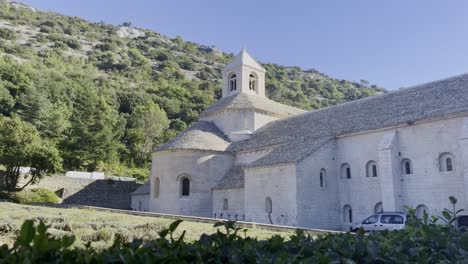 senanque monastery with a historic beautiful church building in good weather in nature with hills in the distance